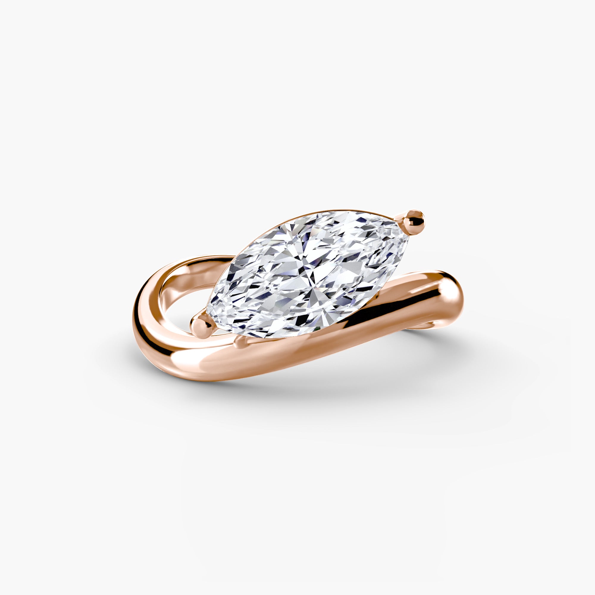 Rose gold ring with a pear-shaped diamond on a white background